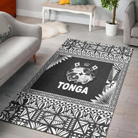 Black Tonga area rug with geometric leaf border and central crest logo