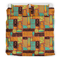 Multicolor tiki pattern bedding set with pineapple and tiki face motif, flat lay