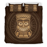 Brown comforter bedding with large tiki mask face in center and aztec-style border