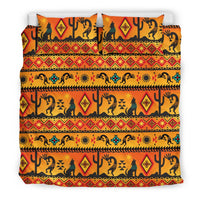 Orange, yellow, and teal Kokopelli bedding set with two pillows and patterned duvet