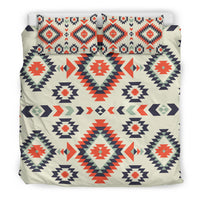 Cream duvet and pillowcases with repeating red, navy, and green geometric motifs