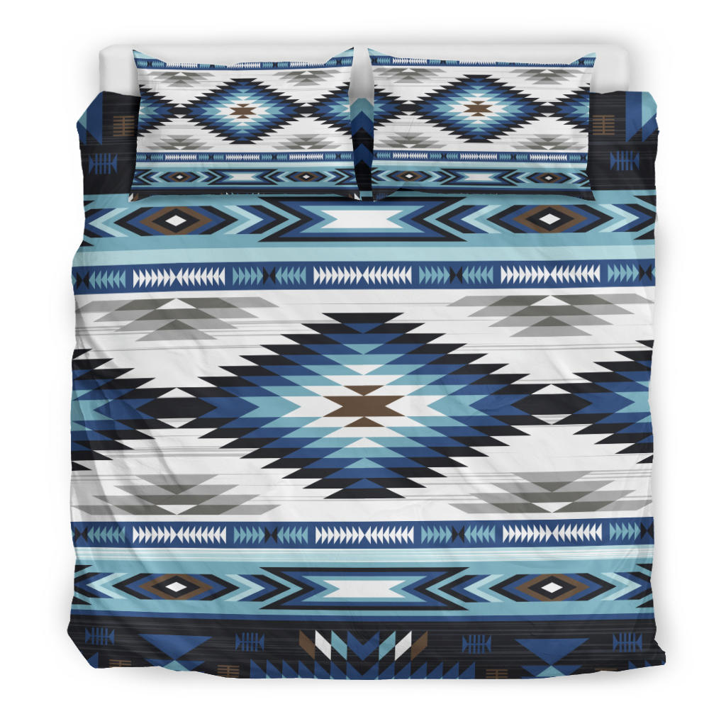 Bedding set close-up: blue, white, and teal starburst tribal center panel