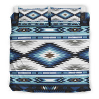 Bedding set close-up: blue, white, and teal starburst tribal center panel