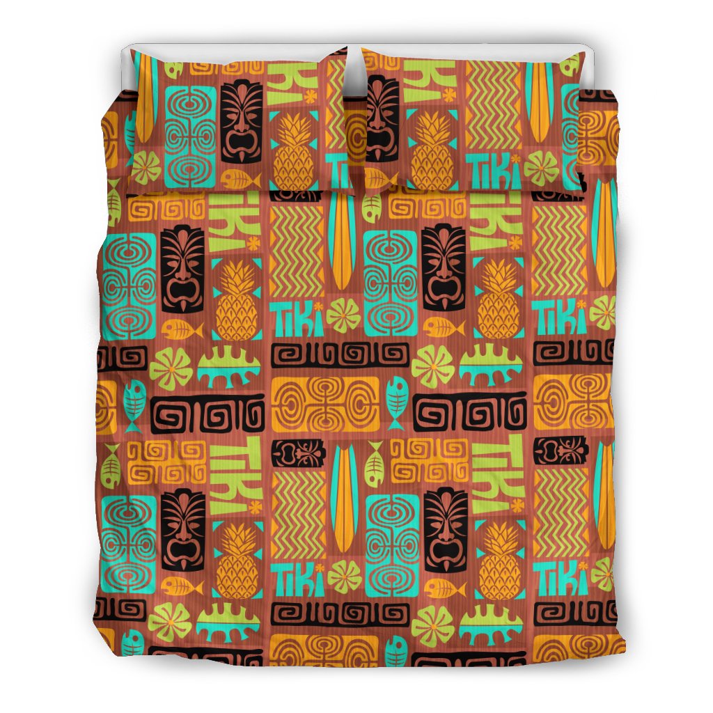 Multicolor tiki pattern bedding set with pineapple, tiki faces, and surfboard shapes