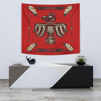 Red tapestry with tribal bird and feather motifs, colorful central figure