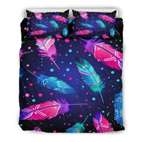 Flat lay of feather-and-dot bedding set: comforter top with two matching pillowcases