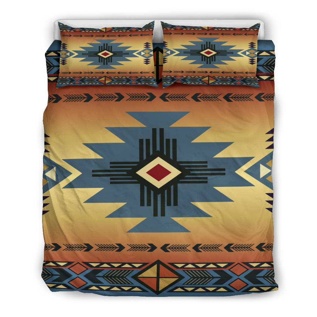 Bedding set laid flat with matching pillows: blue geometric star centerpiece on yellow-orange