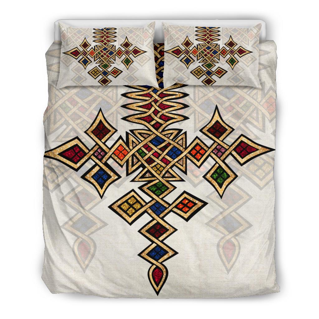 Duvet cover with matching pillows featuring bold multicolor geometric cross pattern