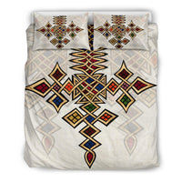 Duvet cover with matching pillows featuring bold multicolor geometric cross pattern