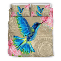 Blue hummingbird and pink hibiscus multicolor bedding set on beige comforter with patterned details