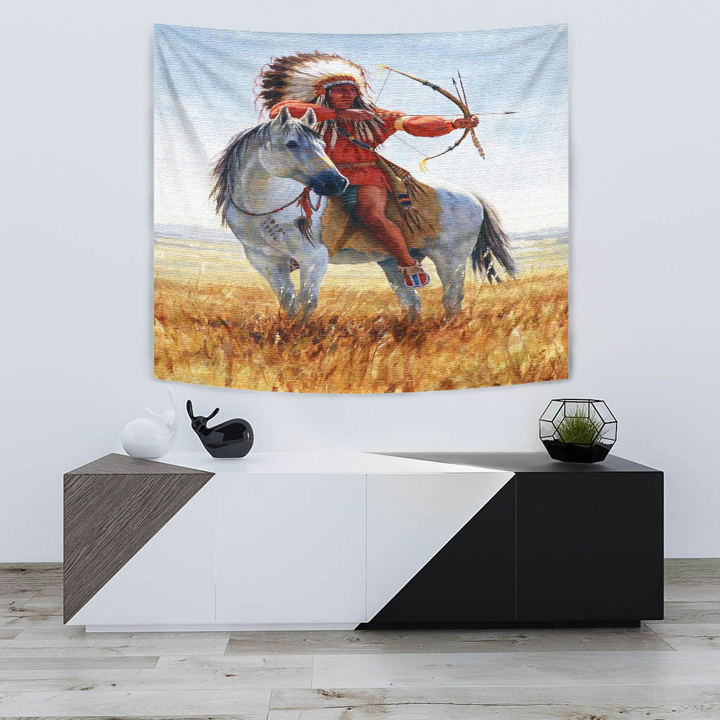 Native American chief in red outfit aiming bow and arrow on white horse tapestry