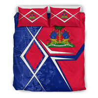 Haiti bedding set showing central crest on red and blue flag quilt with two pillows