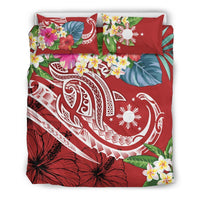 Red tropical bedding set with large hibiscus flowers, leaf accents, and two pillow shams