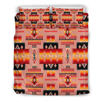 Tan tribal bedding set showing repeating geometric motifs and flame-style icons; includes pillows