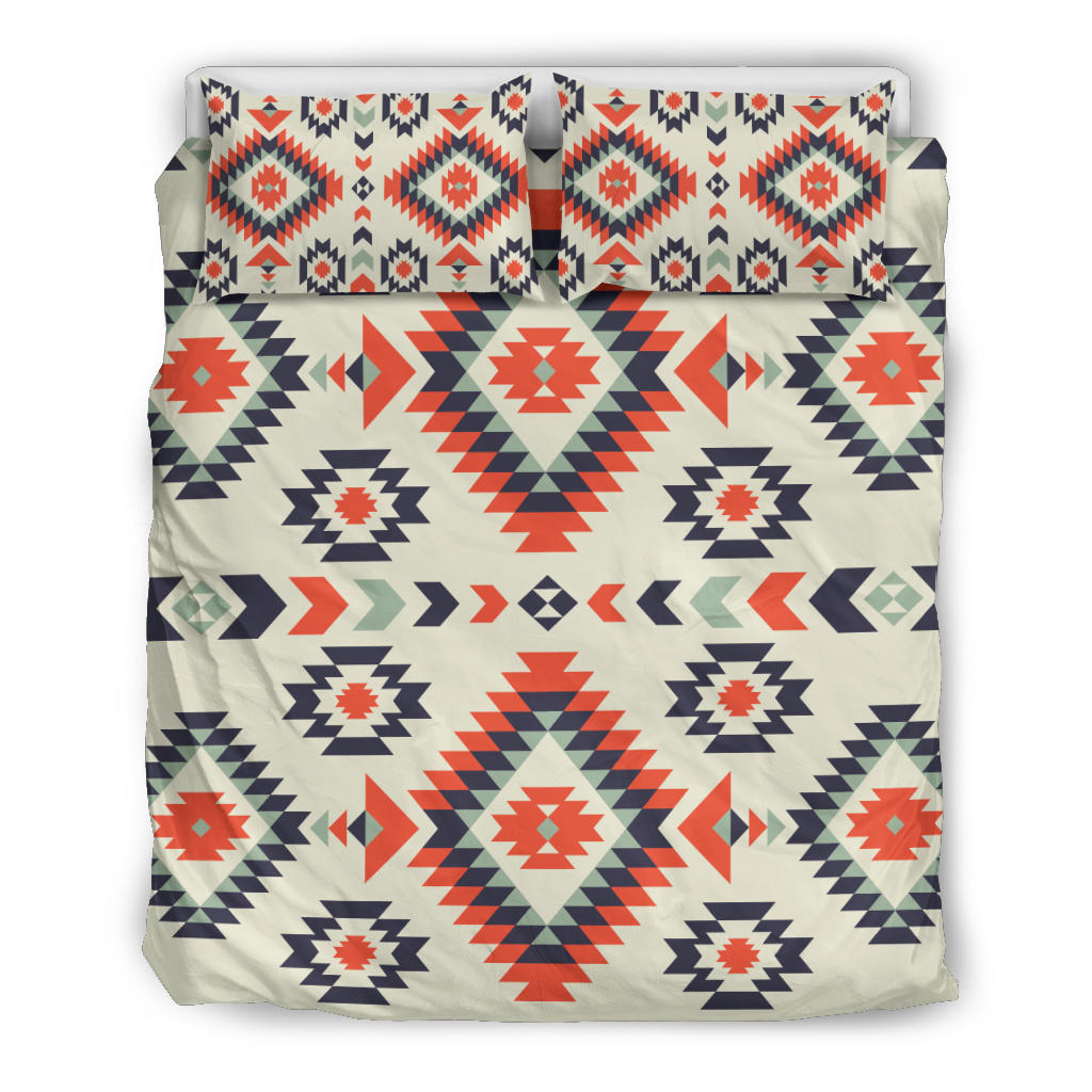 Cream bedding set with bold red, navy, and green geometric aztec-style patterns