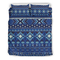Navy bedding set with horizontal geometric bands; teal, cream diamonds and zigzags