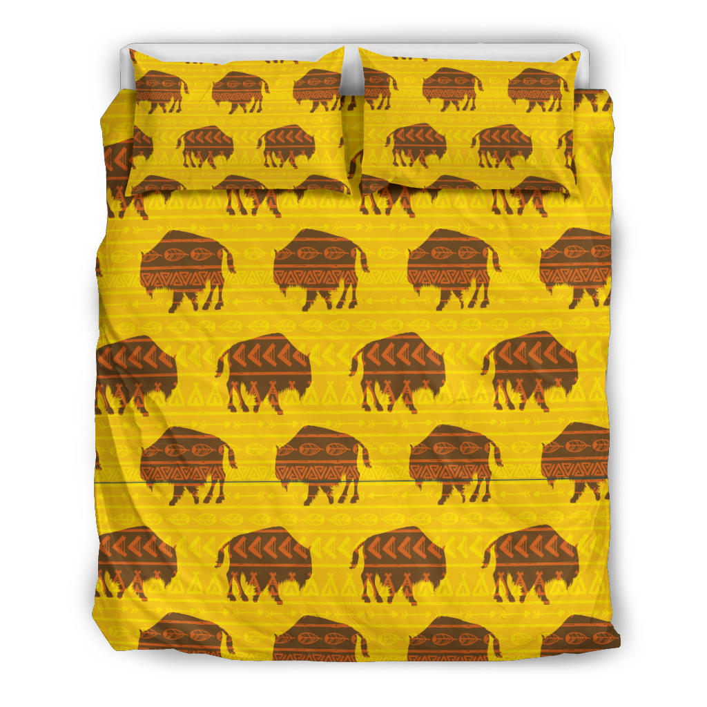 Yellow bedding set featuring bison and teepee-style motifs, two pillowcases and comforter