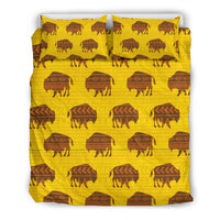 Yellow bedding set featuring bison and teepee-style motifs, two pillowcases and comforter