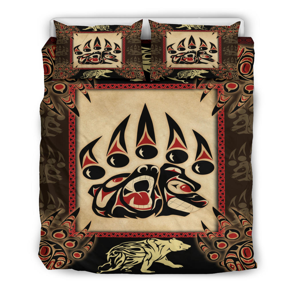 Full bedding set view: tribal bear-face duvet with two pillow shams, red border accents