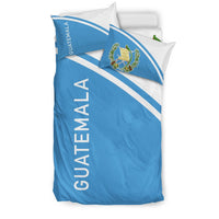 Guatemala bedding set from side: blue front panel, white stripes, two pillowcases