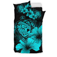 Turquoise hibiscus flowers and tribal artwork on black duvet with matching pillowcase