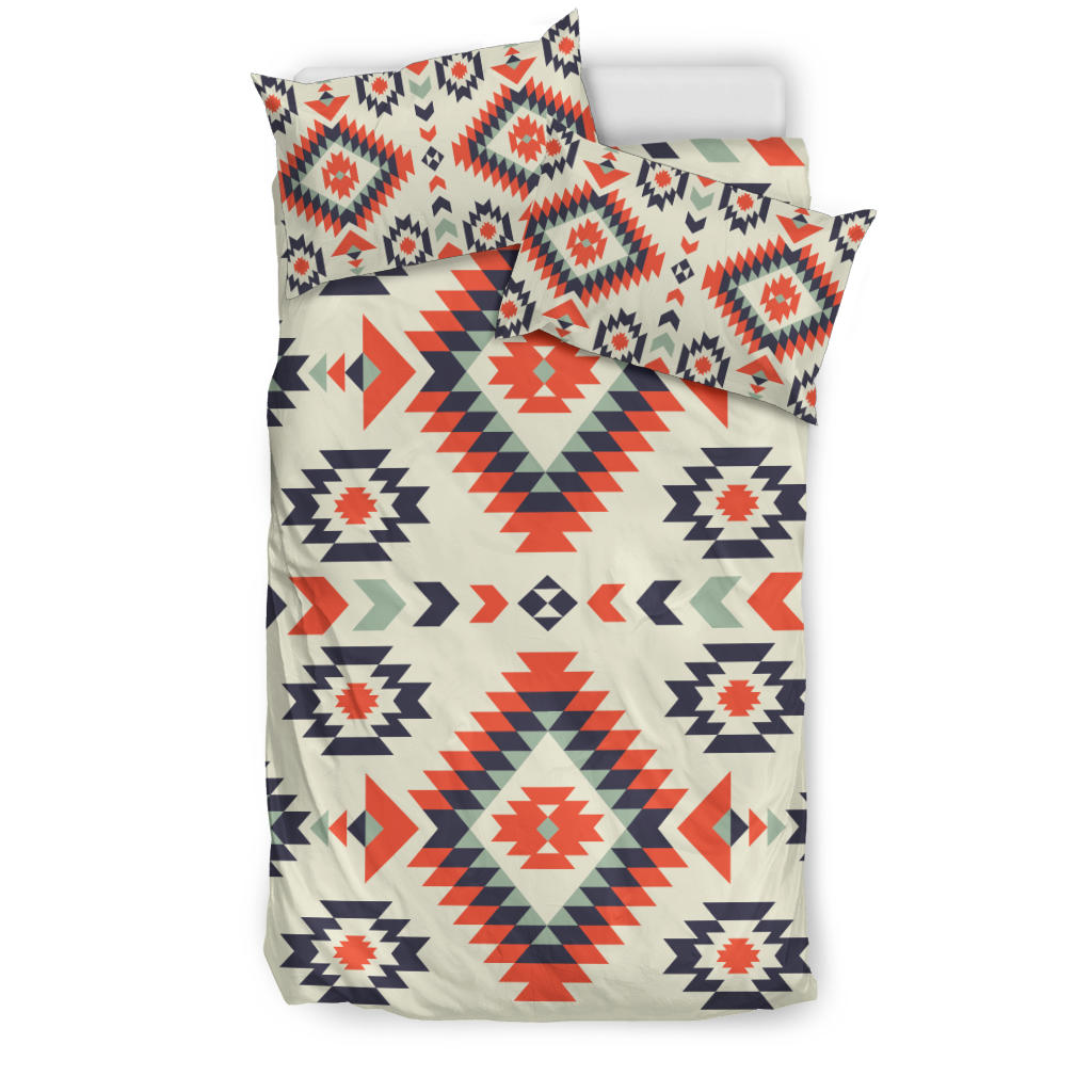 Geometric bedding set: cream duvet with red, navy, and green diamond motifs