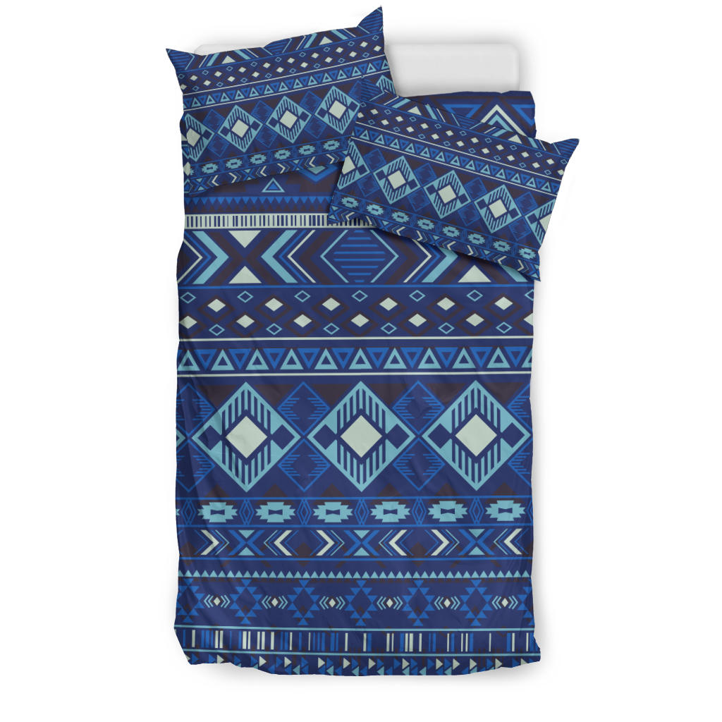 Navy geometric bedding set with teal, cream, and blue diamond stripe pattern