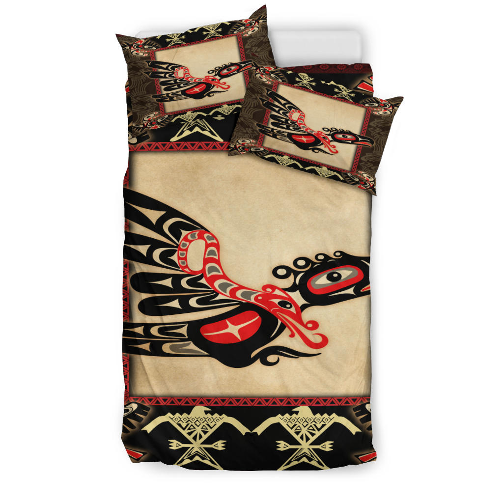 Colorful bedding set: cream panel with black/red thunderbird print; two matching pillows