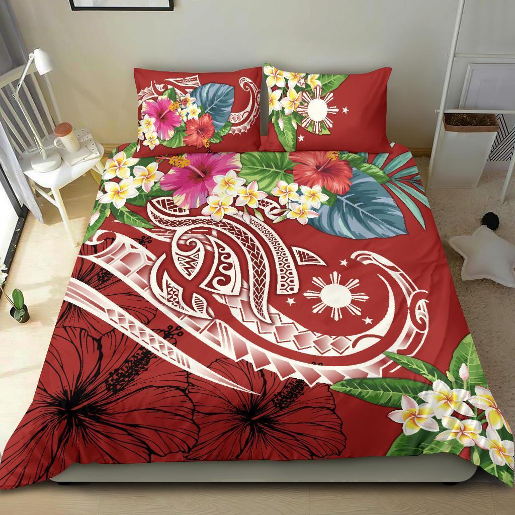 Red tropical bedding set with bold floral print, two pillowcases, and matching duvet
