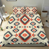 Geometric bedding set with cream duvet and matching pillowcases, red and navy diamonds
