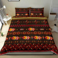Native American feather motif bedding set on bed, dark fabric with red and multicolor design