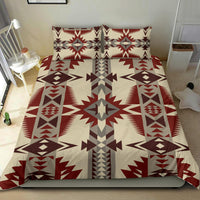 Red, brown, gray, and white Native-inspired bedding with two pillows and bold central star