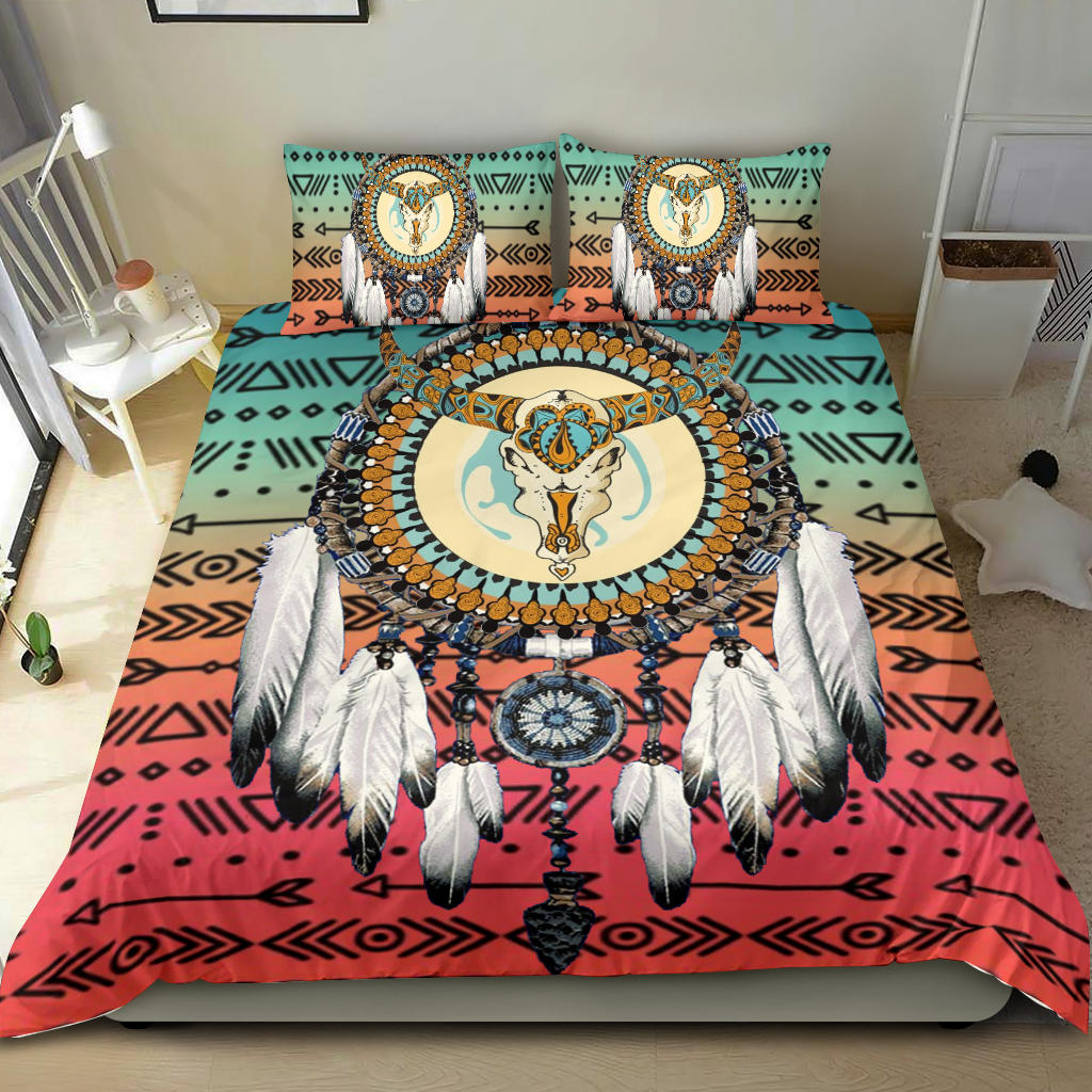 Bedding set on bed: turquoise, tan, and red dreamcatcher center with feather accents