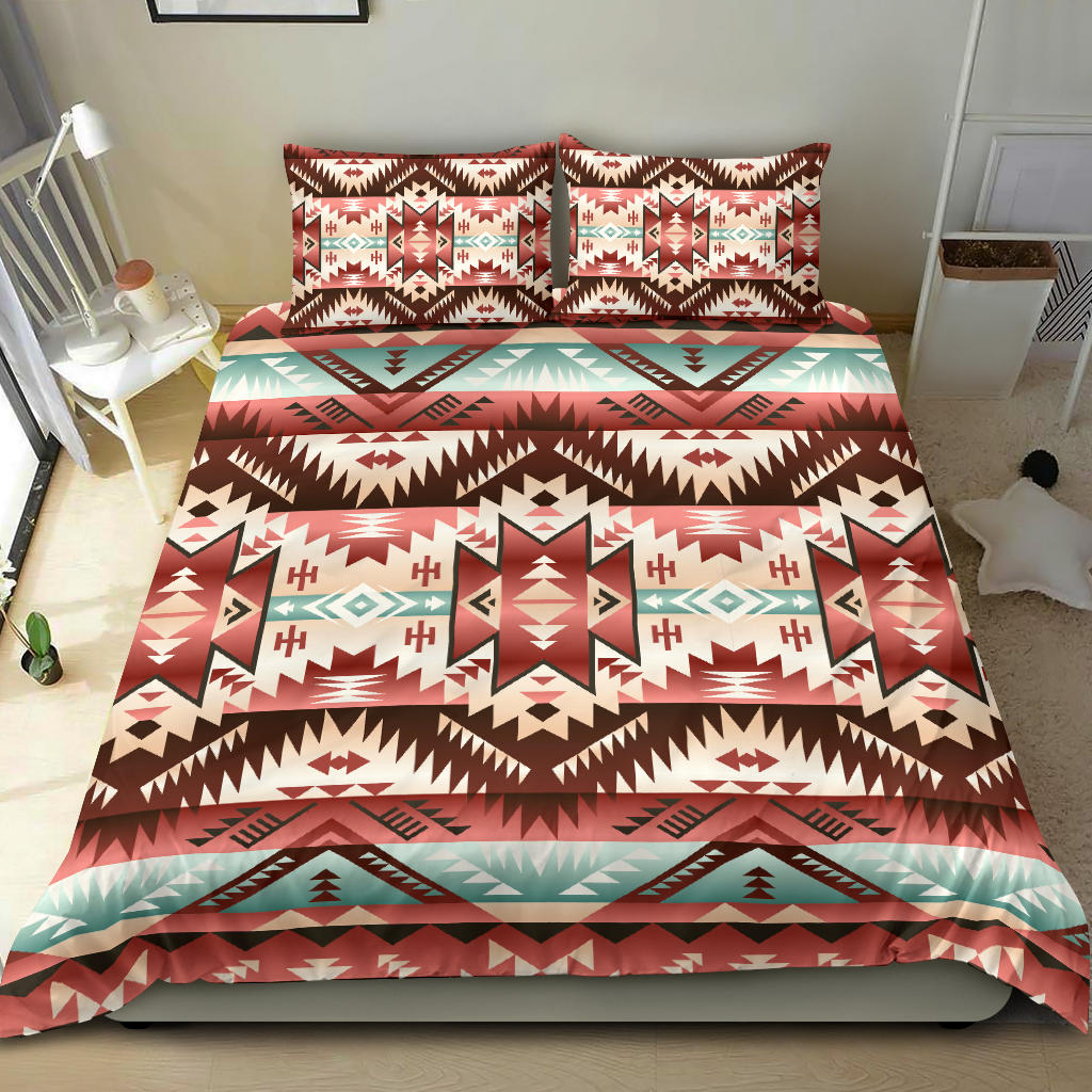 Red tribal Native American bedding set on bed with two sham pillows and patterned duvet