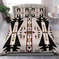 Native American bedding set on bed with layered tribal prints, black-white pattern and red-gold accents