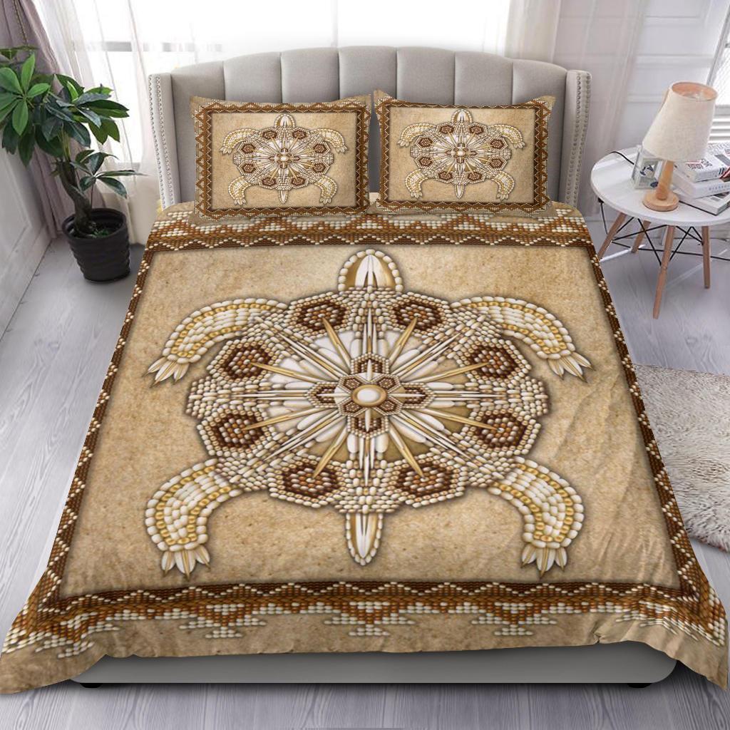 Tan bedding set featuring beaded turtle mandala center and two embroidered pillows