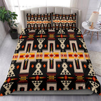 Black duvet cover with multicolor geometric Native-inspired pattern across bed, with 2 pillows