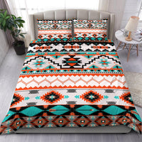 Multicolor Native geometric bedding set with comforter and two pillowcases on bed