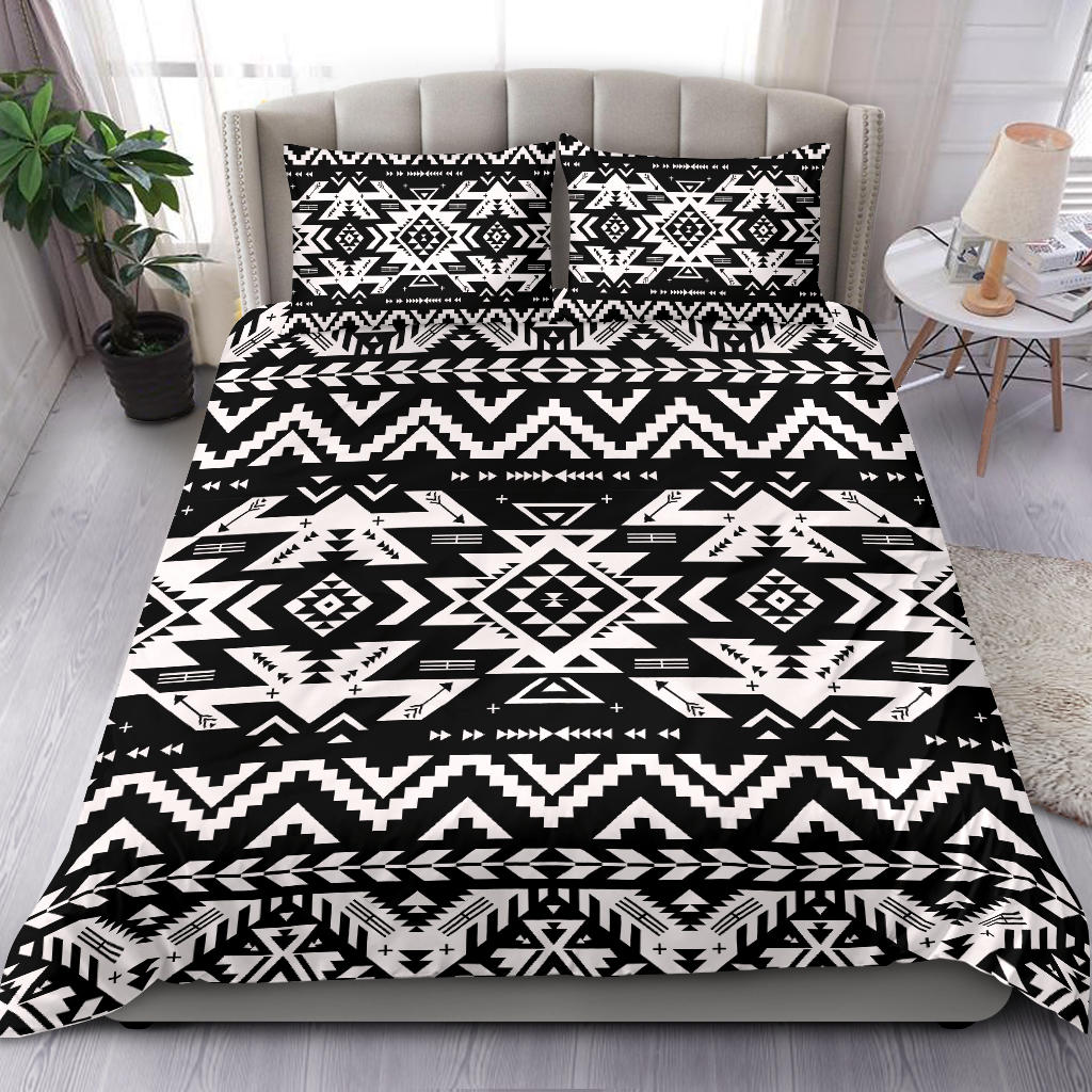 Geometric black-and-white bedding set with two pillowcases on a neatly styled bed