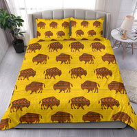 Yellow bedding set showing bison and geometric motifs on duvet with two matching pillows