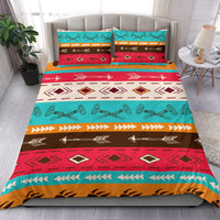 Colorful tribal bedding set on bed: teal, red, brown stripes, arrows, and diamond shapes
