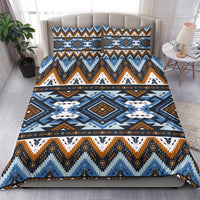 Bedspread and two pillow shams featuring tribal geometric patterns in blue, orange, and white
