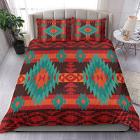 Patterned bedding set with red, teal, and orange geometric duvet and two pillows
