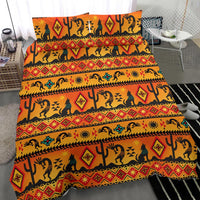 Orange and yellow tribal bedding set with Kokopelli silhouettes, stripes, and geometric diamonds