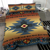 Close-up of duvet: blue star medallion with southwestern geometric border on yellow-orange base