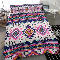 Close-up of multicolor Native geometric bedding with diamond motifs, pink and teal