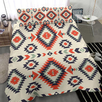Geometric bedding set: cream quilt with red, navy, and green repeating diamond motifs