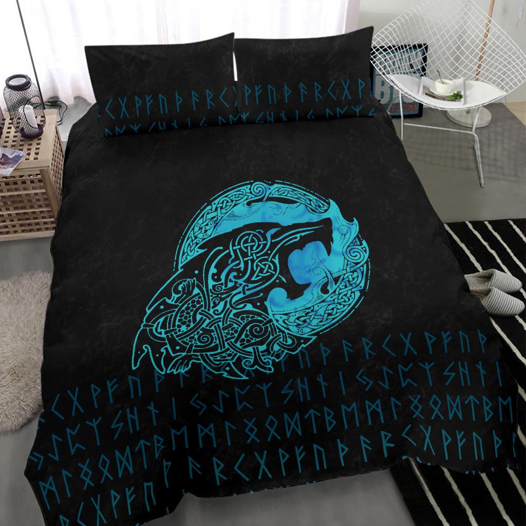 Black duvet close-up with cyan wolf emblem and rune symbols; two pillows