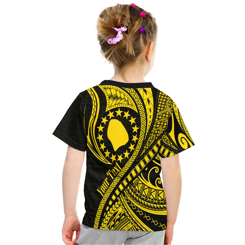 Kids black and gold graphic T-shirt, back view with circular emblem and Polynesian wave motifs