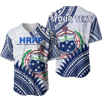 White baseball jersey with HRPP logo, Samoan crest and Polynesian geometric pattern